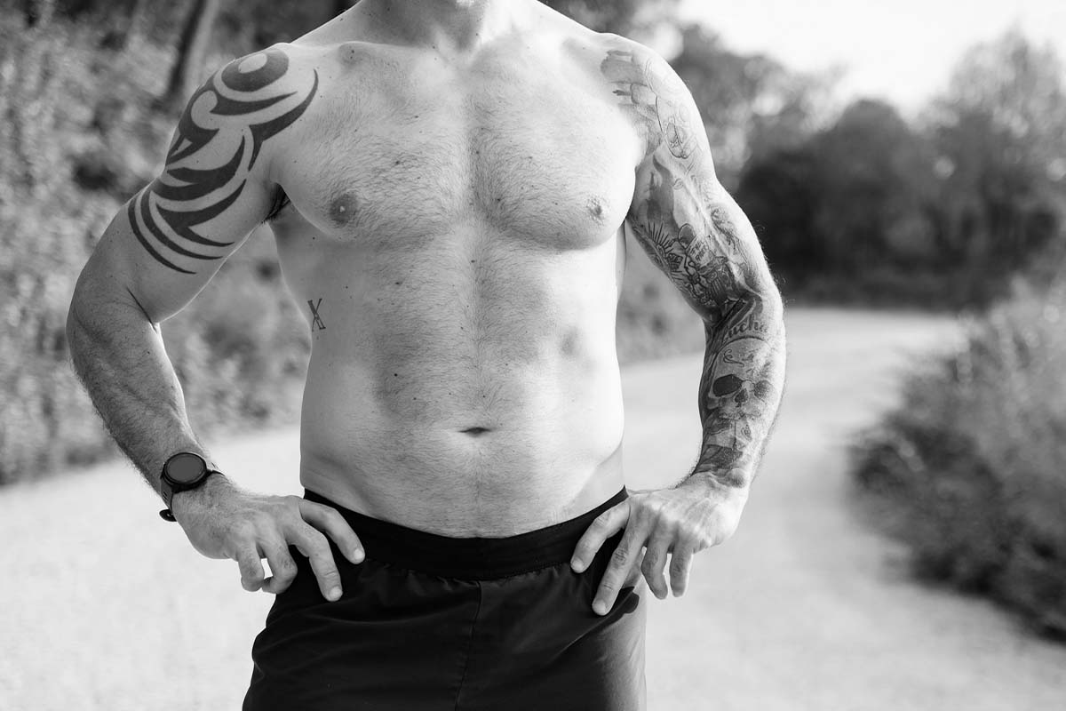 a man's bare torso, standing outside with his hands on his hips, after skin tightening in Dallas