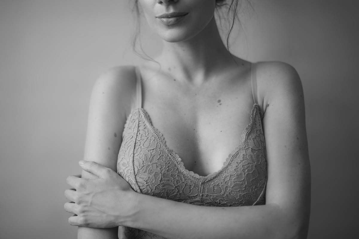 a woman crossing her arms and wearing a bralette after a mastopexy in Dallas